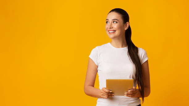 istock Happy Woman Holding Tablet And Looking Aside At Copy Space 1165465809