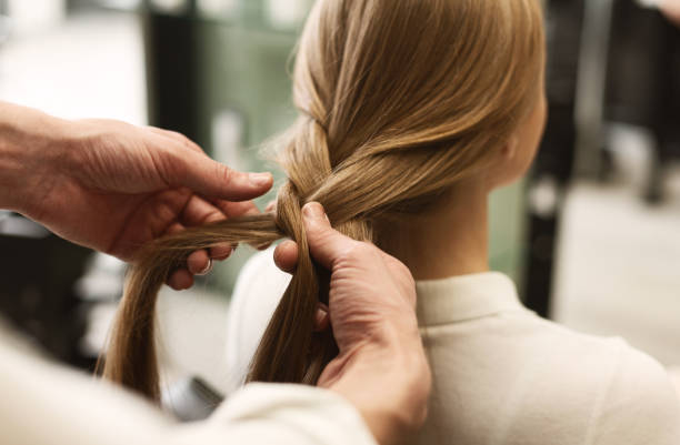 Stylist Braiding Girl's Hair In Beauty Studio, Closeup Professional Stylist Braiding Girl's Long Hair In Beauty Salon. Selective Focus, Closeup. Panorama With Empty Space For Text Pigtails stock pictures, royalty-free photos & images