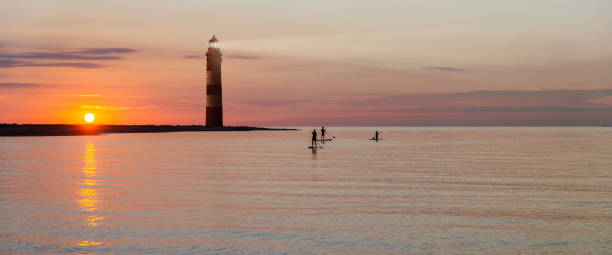 istock Lighthouse on the beach of an island in sunset with text space 1165466755