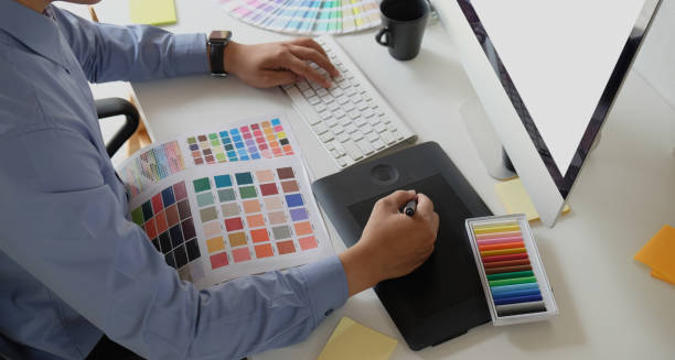 istock Graphic designer working with drawing tablet and colour swatches 1165466765