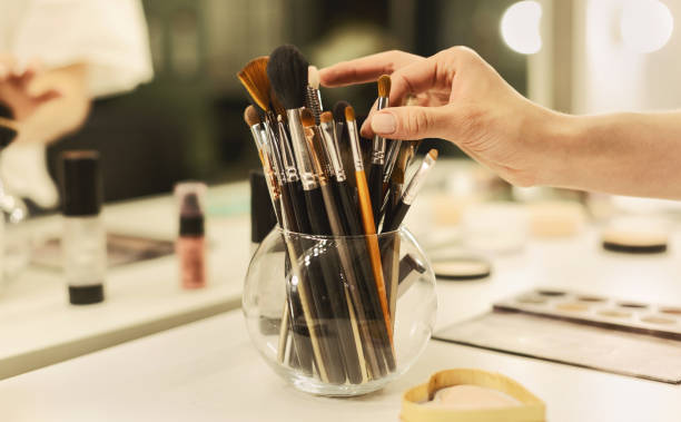 istock Makeup Artist's Hand Taking Brush From Vase With Professional Tools 1165466984