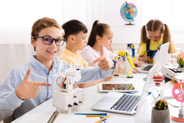 istock Boy showing his robot. Proud student of his project 1165466989