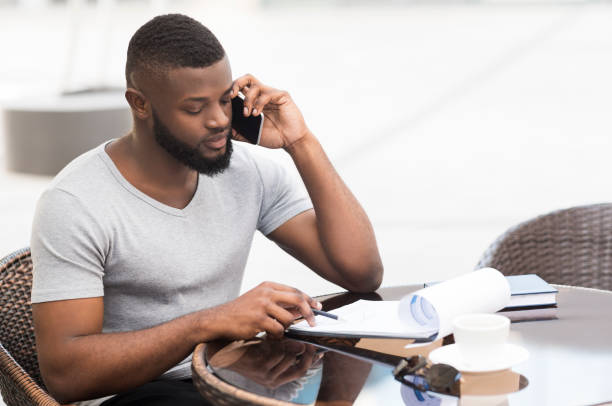 istock African businessman working with important data in cafe 1165466995