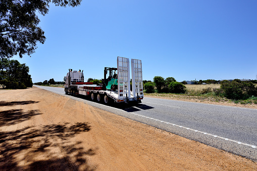 Heavy truck at outback road in sunny day, Western Australia.