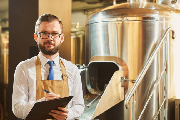 istock Expert of brewery holding folder, posing, looking at camera. 1165468012