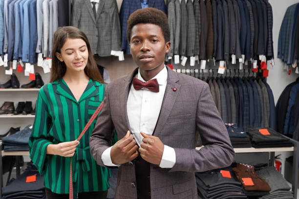 istock African man posing, fitting grey suit in boutique. 1165468082