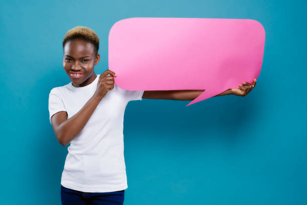 istock African woman holding cardboard with copy space for text. 1165468083