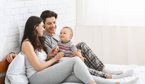 istock Happy baby looking at mother in bed 1165468197