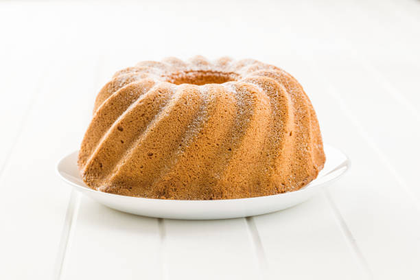 Sweet bundt cake on white table.