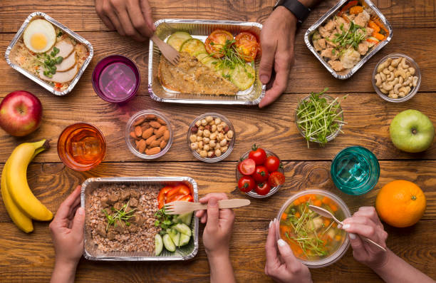 istock Family eating from take away boxes on wooden table 1165470465