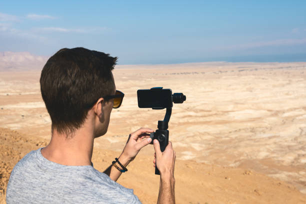 istock young man using gimbal in the desert of israel 1165470970