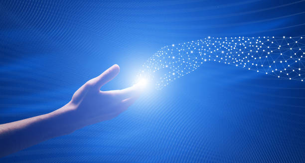 istock Robotic Cooperation. Touching Fingers of Real and Digital Man 1165471746