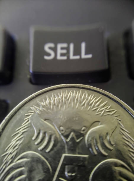 Australian five cent coin and sell key macro Top down angled close-up macro part view of an Australian five cent coin in foreground with blurred financial sell key background illustrating financial concept. australian 5 cents stock pictures, royalty-free photos & images