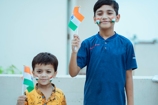 Indian small boys holding flag outdoor shoot. shoot location Delhi