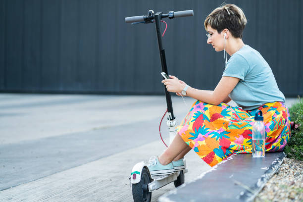 istock Business woman using electric scooter 1165474068