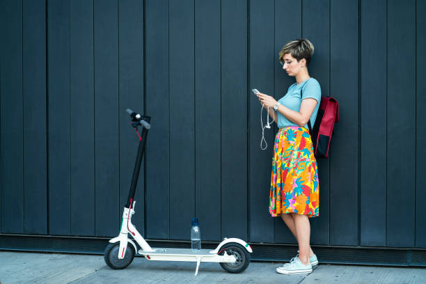 Business woman using electric scooter