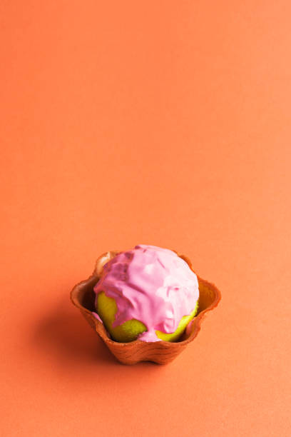 Tennis ball with pink paint in waffle cup