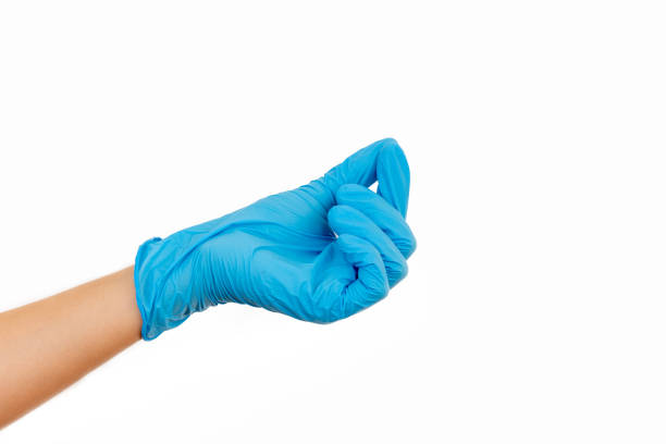 istock hand in a blue rubber glove holding something on white background 1165478701