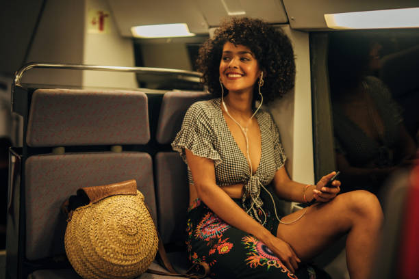 istock Curly haired woman riding in train 1165479104