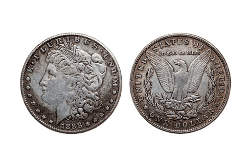 USA One Dollar Morgan Silver Coin replica dated 1880 with a portrait image of Liberty on the obverse and a spread eagle on the reverse cut out and isolated on a white background