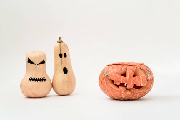 istock Funny scary face Halloween pumpkins on white background. 1165483120