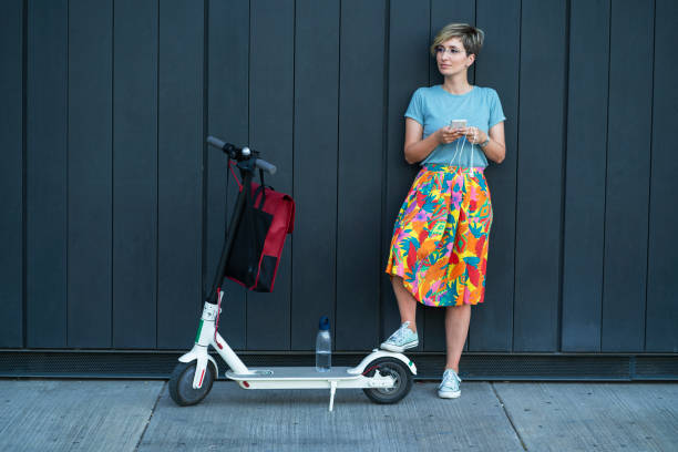 istock Business woman using electric scooter 1165485082
