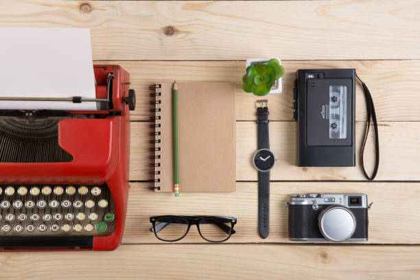 istock Writer or journalist workplace vintage red typewriter, photo camera, cassette recorder on the wooden desk 1165486321
