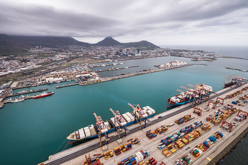Flying with a helicopter over Cape Town Port during the calm before the storm