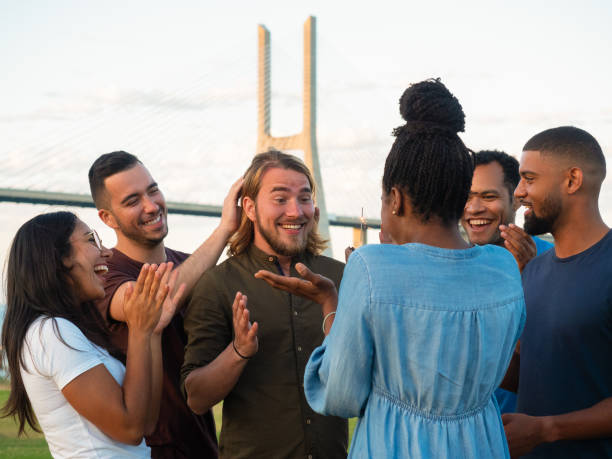istock Cheerful young people making surprise for male friend. 1165487713