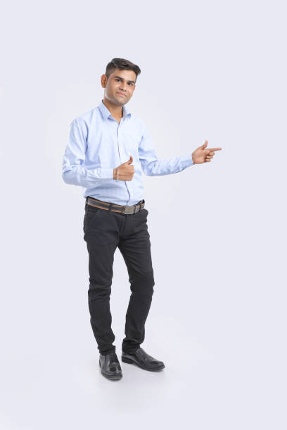 istock Young Indian Man Showing Direction With Hand 1165489485
