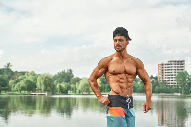 istock Man with muscular naked torso showing muscles. 1165489538