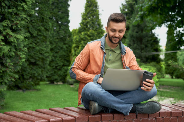 istock Student working with laptop in garden. 1165489591