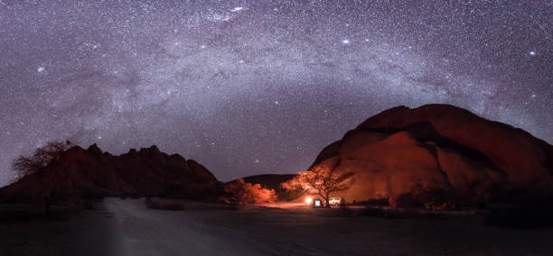 Camping under the milky way stars with a camp fire in Spitzkoppe, Namibia