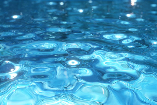 istock Pure blue water in the pool with light reflections. Water droplets falling to the surface. 3d illustration 1165491813