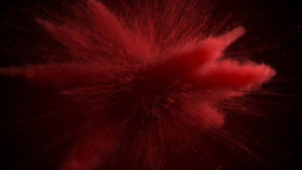 istock 3d illustration of red colored powder explosion isolated on black background. 1165491995