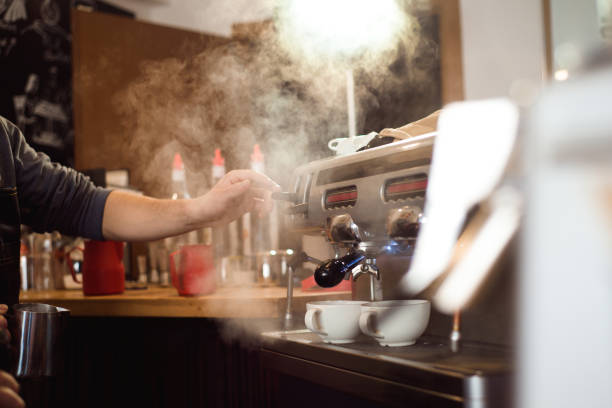 istock Barista making coffee using a coffee machine, hospitality and hot beverage concept. 1165493807