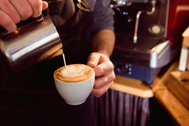 istock Coffee Latte Barista making pattern in a cup of coffee shop. 1165493886