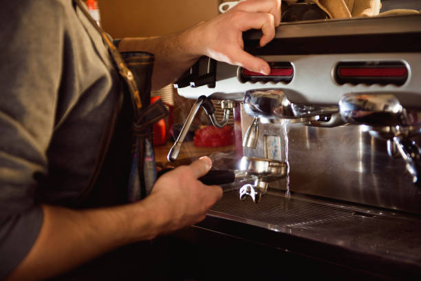istock close up barista hand making a cup of coffee 1165493903
