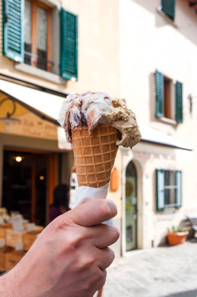 istock The man holding delicious ice cream in wafer cone. 1165494655