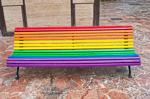 Rainbow coloured bench  in the city in Valencia, Spain