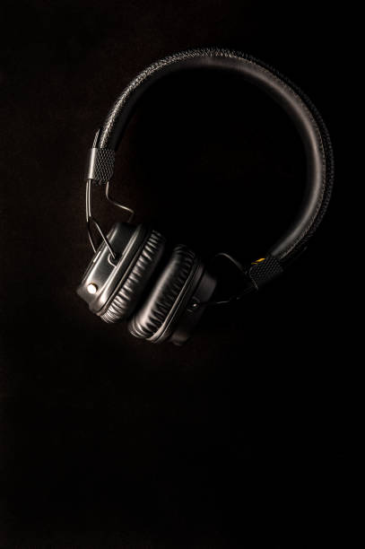 istock Black stylish headphones on black background. 1165495168