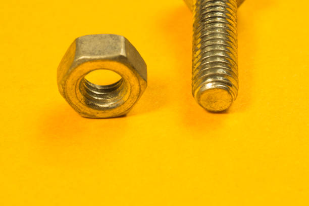 istock Steel screws on a yellow background 1165496488