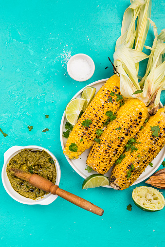 BBQ Grilled Corn on Con with Lime and Salt, Mexican Street Food.