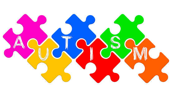 Autism word written on puzzles. Autism spectrum disorder concept.