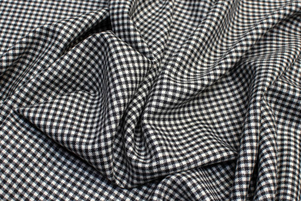 istock Texture of woolen fabric in a black and white checker. Background, pattern. 1165496596