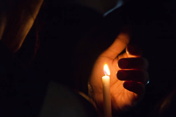 istock Blurred image for background of hand with candle. 1165497082