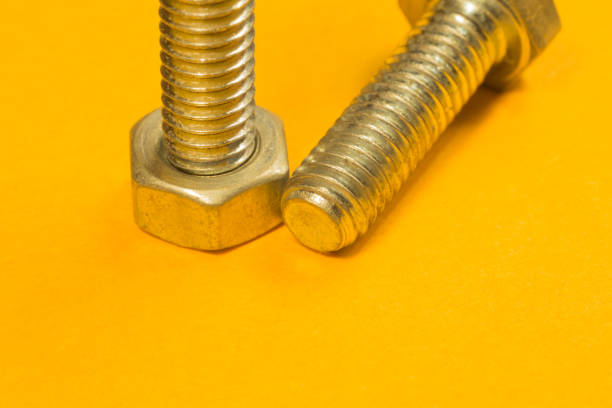 istock Steel screws on a yellow background 1165498215