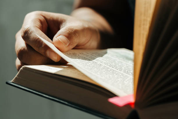 de cerca de las manos del joven sostener y leer la santa biblia. concepto de fe cristiana - biblia fotografías e imágenes de stock