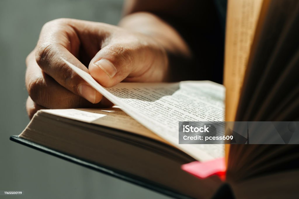 Close up of young man hands hold and reading holy bible.Christian faith concept Bible Stock Photo