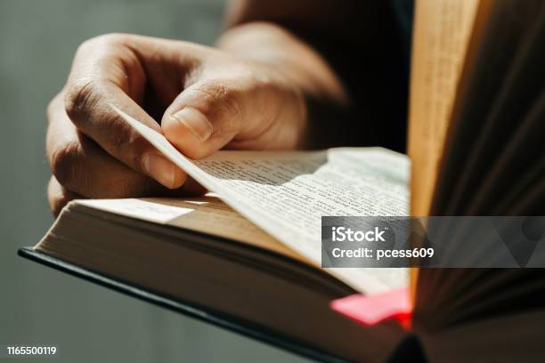 Close Up Of Young Man Hands Hold And Reading Holy Biblechristian Faith Concept Stock Photo - Download Image Now
